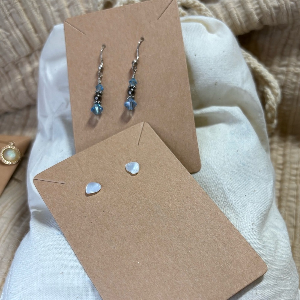 Two pair one is a shell stud the other is a small silver & crystal drop w/ glass